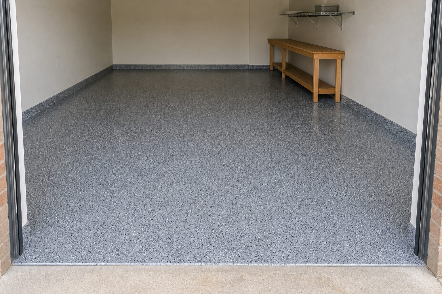 Finished flake epoxy garage floor in a Sydney home with a crisp edge at the roller door threshold and reflections along the slab